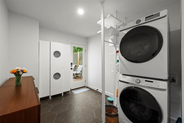 109 W 55th 1/2 St, Austin, TX 78751 - laundry room featuring stacked washing machine and dryer, dark tile patterned flooring, and baseboards
