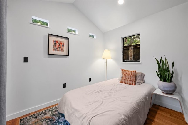 109 W 55th 1/2 St, Austin, TX 78751 - bedroom with lofted ceiling, wood finished floors, and baseboards