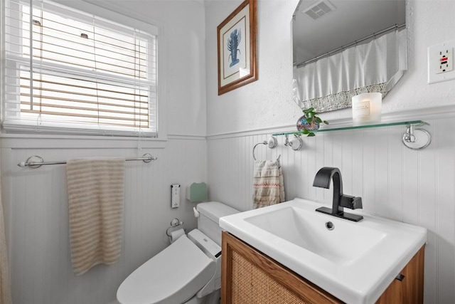 109 W 55th 1/2 St, Austin, TX 78751 - full bathroom featuring wainscoting, vanity, and toilet