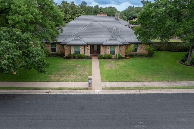 11141 Pinehurst Dr, Austin, TX 78747 - view of front of property featuring a chimney and a tile roof