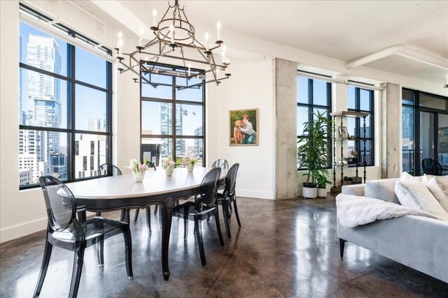 311 W 5th St W Unit 902, Austin, TX 78701 - dining area with finished concrete floors, a chandelier, baseboards, and plenty of natural light