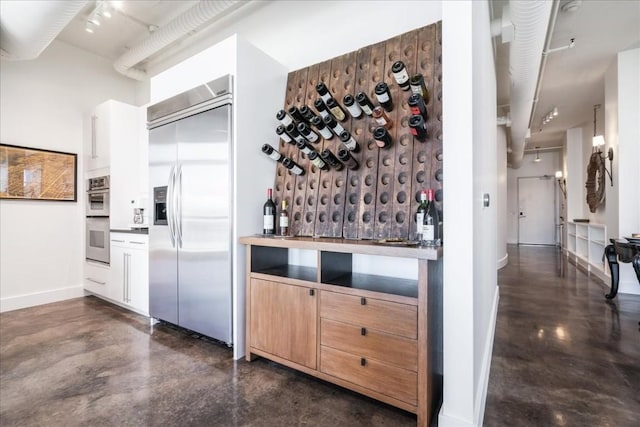 311 W 5th St W Unit 902, Austin, TX 78701 - wine room with concrete floors, baseboards, and a bar