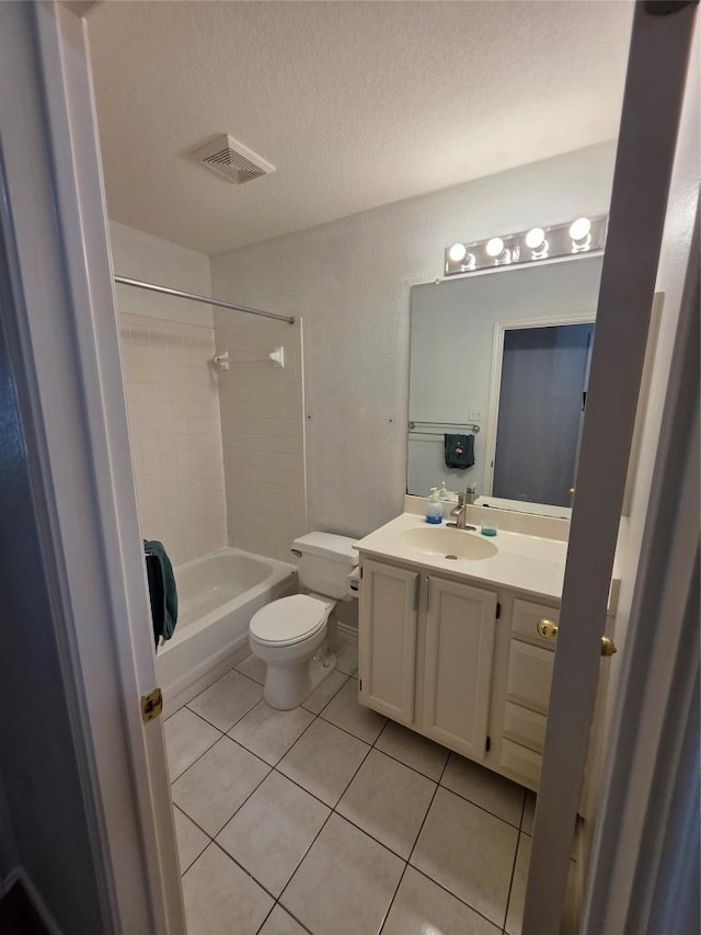 3401 Kissman Dr, Austin, TX 78728 - bathroom with toilet, tile patterned floors, vanity, shower / washtub combination, and a textured ceiling