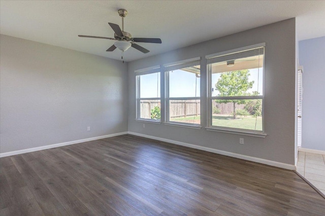 1519 Shenandoah Cv, Lockhart, TX 78644 - empty room featuring dark wood-type flooring, baseboards, and a ceiling fan