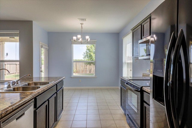 1519 Shenandoah Cv, Lockhart, TX 78644 - kitchen featuring black appliances, a sink, a chandelier, baseboards, and decorative light fixtures