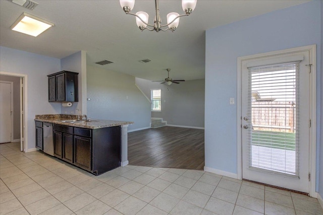 1519 Shenandoah Cv, Lockhart, TX 78644 - kitchen with a sink, dark brown cabinets, dishwasher, a chandelier, and baseboards