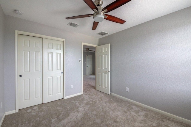 1519 Shenandoah Cv, Lockhart, TX 78644 - unfurnished bedroom featuring carpet, a closet, baseboards, and ceiling fan