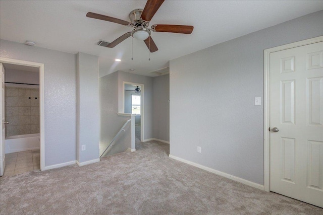 1519 Shenandoah Cv, Lockhart, TX 78644 - unfurnished bedroom featuring carpet, ensuite bathroom, baseboards, and ceiling fan