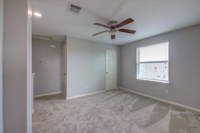 1519 Shenandoah Cv, Lockhart, TX 78644 - empty room featuring carpet, a ceiling fan, baseboards, and attic access
