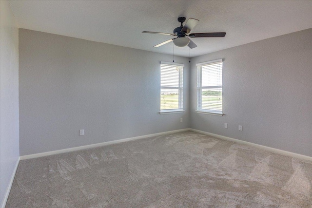 1519 Shenandoah Cv, Lockhart, TX 78644 - empty room featuring carpet flooring, a ceiling fan, and baseboards
