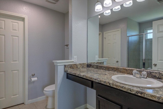 1519 Shenandoah Cv, Lockhart, TX 78644 - bathroom featuring a stall shower, toilet, tile patterned floors, vanity, and a textured wall