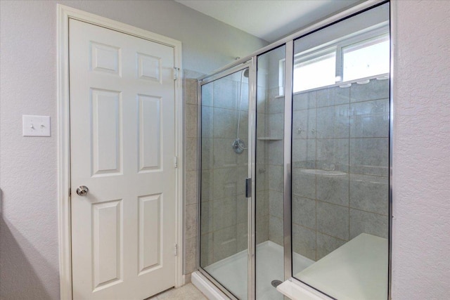 1519 Shenandoah Cv, Lockhart, TX 78644 - bathroom with a shower stall and a textured wall