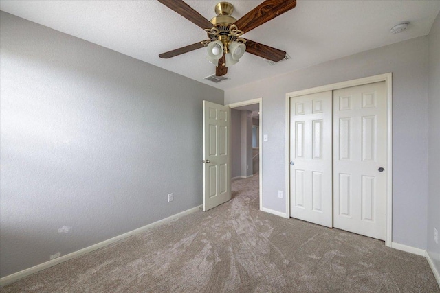 1519 Shenandoah Cv, Lockhart, TX 78644 - unfurnished bedroom featuring carpet flooring, baseboards, a closet, and ceiling fan