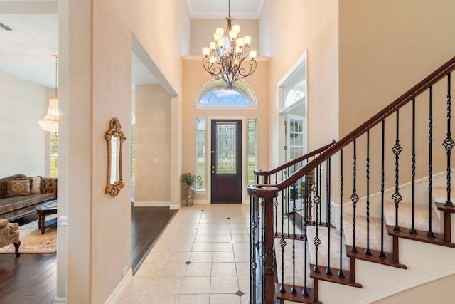 15 Sarazen Loop N, Georgetown, TX 78628 - foyer with a high ceiling, stairway, a chandelier, crown molding, and wood finished floors