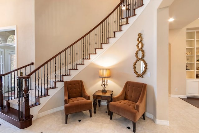 15 Sarazen Loop N, Georgetown, TX 78628 - staircase with healthy amount of natural light, a high ceiling, and tile patterned flooring