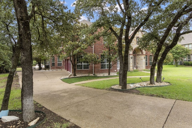 15 Sarazen Loop N, Georgetown, TX 78628 - view of property hidden behind natural elements featuring brick siding, concrete driveway, a front lawn, and a garage