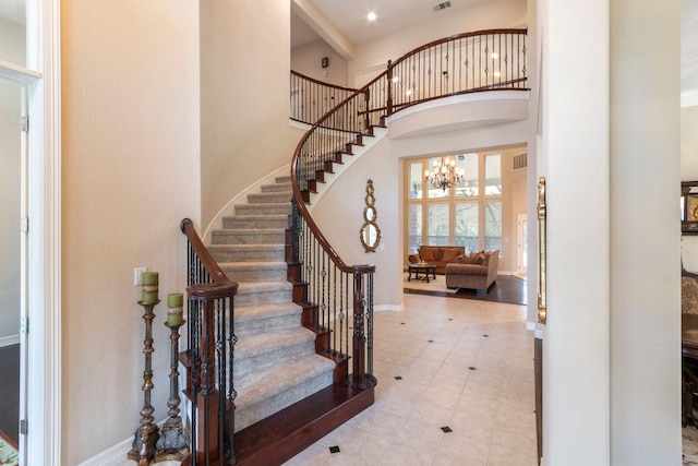 15 Sarazen Loop N, Georgetown, TX 78628 - foyer featuring a high ceiling, stairway, a chandelier, and tile patterned flooring