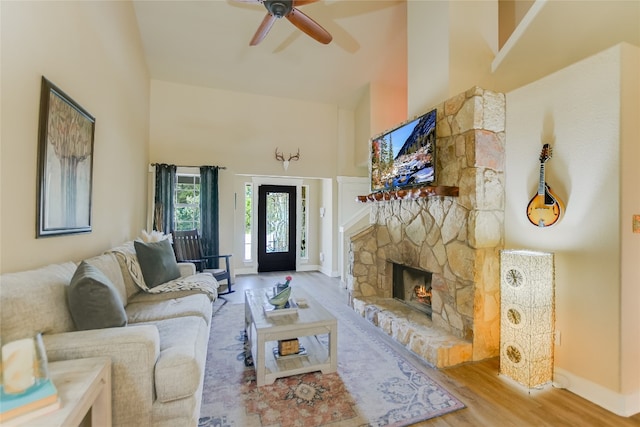 43 Wood Glen Dr, Wimberley, TX 78676 - living room with high vaulted ceiling, wood finished floors, a fireplace, a ceiling fan, and baseboards