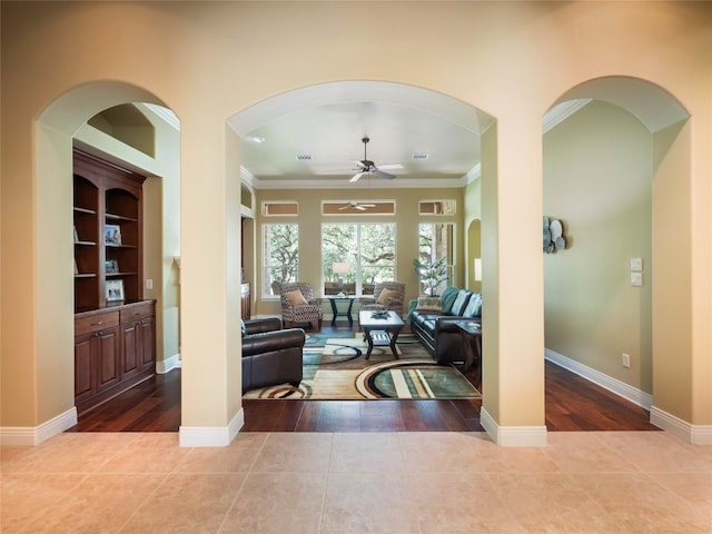 104 E Rustle Cv, Georgetown, TX 78628 - living room featuring a ceiling fan, wood finished floors, ornamental molding, and baseboards