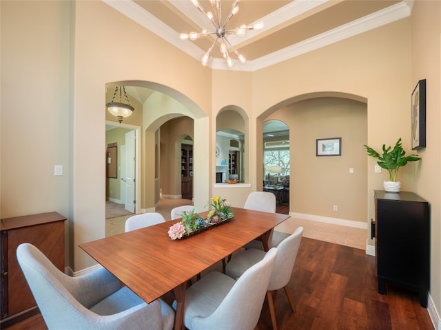 104 E Rustle Cv, Georgetown, TX 78628 - dining area with arched walkways, wood finished floors, ornamental molding, a chandelier, and baseboards