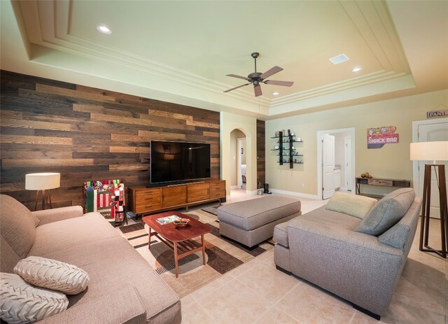 104 E Rustle Cv, Georgetown, TX 78628 - living room featuring a tray ceiling, arched walkways, a ceiling fan, recessed lighting, and light tile patterned floors