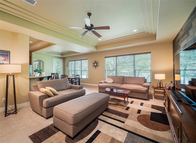 104 E Rustle Cv, Georgetown, TX 78628 - living area featuring baseboards, a tray ceiling, ceiling fan, crown molding, and recessed lighting
