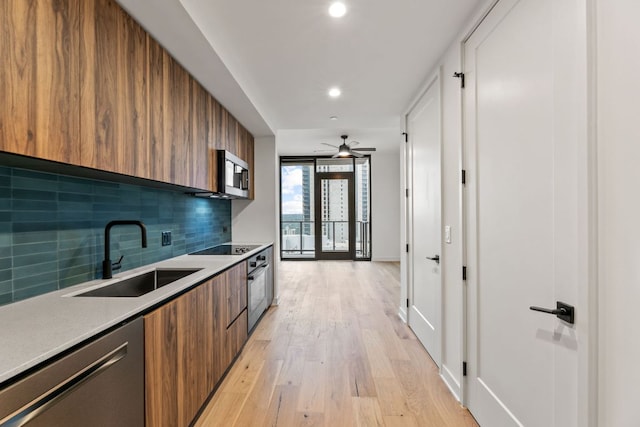 84 E Ave Unit 2108, Austin, TX 78701 - kitchen with modern cabinets, stainless steel appliances, a sink, brown cabinetry, and tasteful backsplash