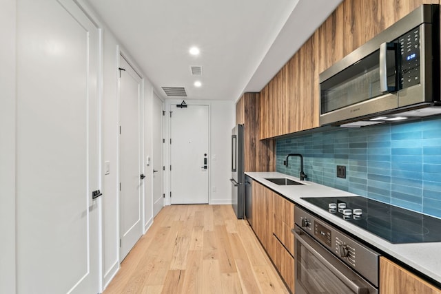 84 E Ave Unit 2108, Austin, TX 78701 - kitchen with appliances with stainless steel finishes, a sink, brown cabinets, modern cabinets, and recessed lighting