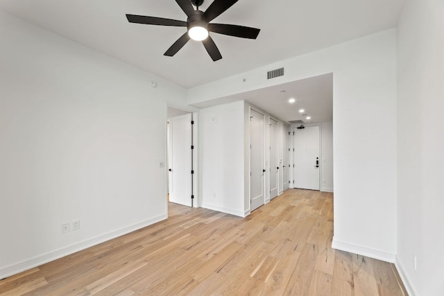 84 E Ave Unit 2108, Austin, TX 78701 - spare room featuring light wood finished floors, a ceiling fan, baseboards, and recessed lighting