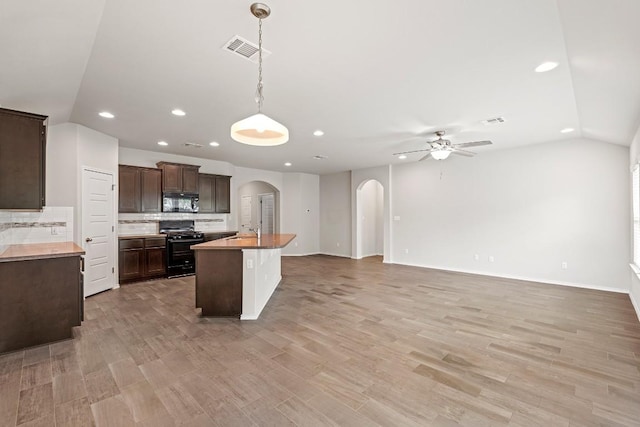 1012 Chad Loop, Round Rock, TX 78665 - kitchen featuring black appliances, arched walkways, recessed lighting, a ceiling fan, and dark brown cabinets