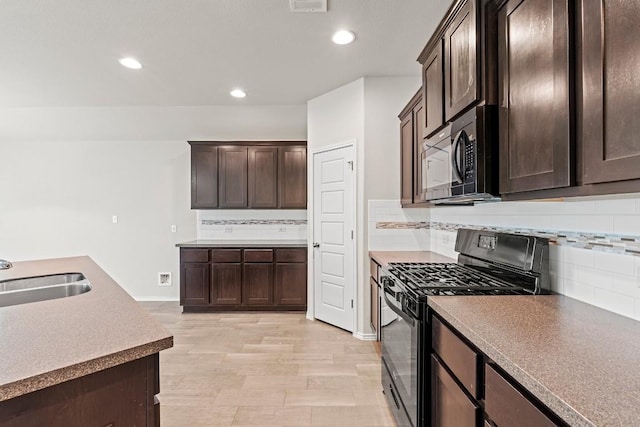 1012 Chad Loop, Round Rock, TX 78665 - kitchen with black appliances, dark brown cabinetry, recessed lighting, and backsplash