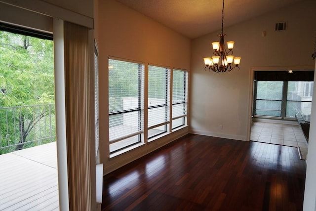 1520 Ben Crenshaw Way Unit 120, Austin, TX 78746 - unfurnished dining area with vaulted ceiling, a chandelier, dark wood finished floors, and baseboards