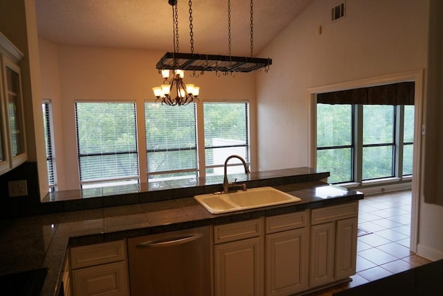 1520 Ben Crenshaw Way Unit 120, Austin, TX 78746 - kitchen featuring dishwasher, a sink, lofted ceiling, a chandelier, and light tile patterned flooring