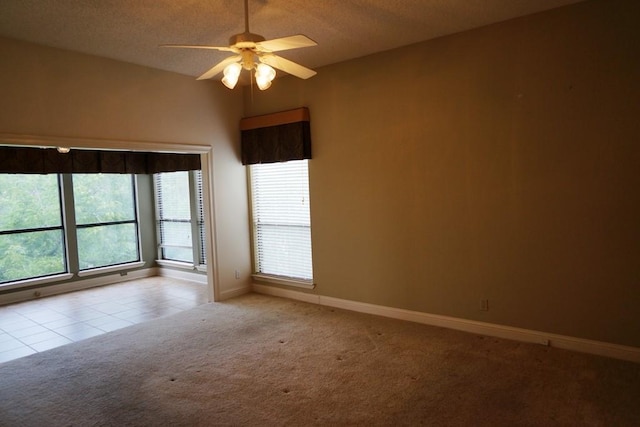 1520 Ben Crenshaw Way Unit 120, Austin, TX 78746 - tiled spare room featuring carpet, a ceiling fan, baseboards, and a textured ceiling