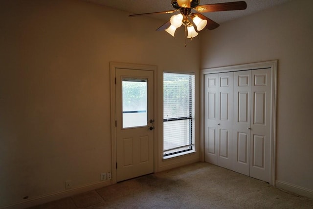 1520 Ben Crenshaw Way Unit 120, Austin, TX 78746 - foyer entrance with ceiling fan, healthy amount of natural light, light colored carpet, and baseboards