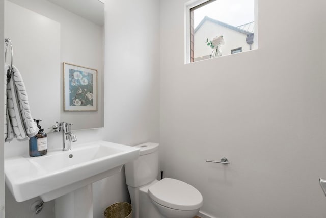 3100 Menchaca Rd Unit 33, Austin, TX 78704 - half bathroom featuring toilet and a sink