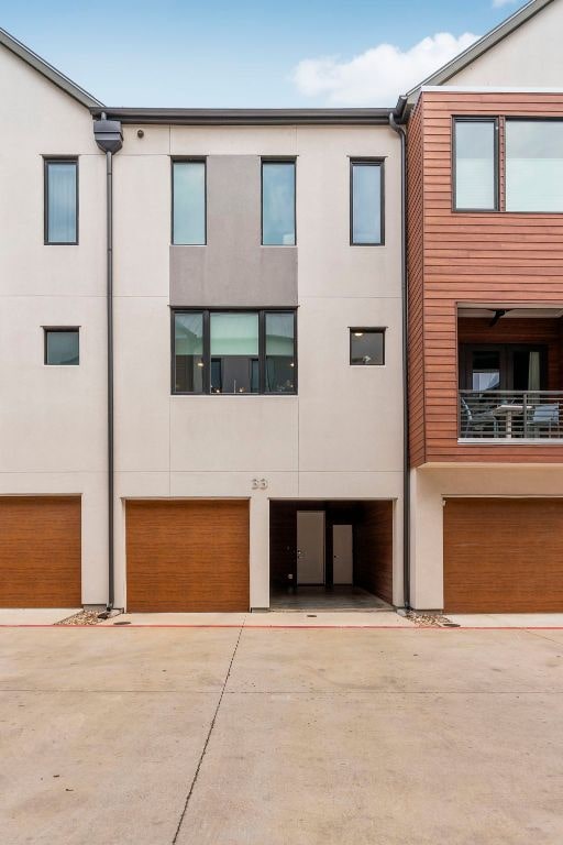 3100 Menchaca Rd Unit 33, Austin, TX 78704 - view of front of house featuring stucco siding and a garage