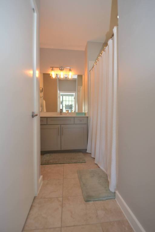 6000 S Congress Ave Unit 132, Austin, TX 78745 - bathroom with vanity, tile patterned floors, and a shower with curtain