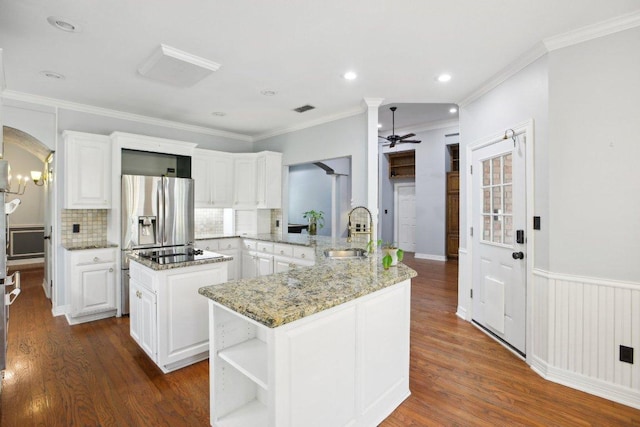 30418 La Quinta Dr, Georgetown, TX 78628 - kitchen featuring a sink, a kitchen island, ceiling fan, white cabinets, and ornamental molding