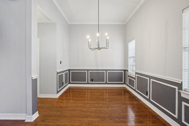 30418 La Quinta Dr, Georgetown, TX 78628 - unfurnished dining area featuring a chandelier, ornamental molding, wood finished floors, and wainscoting