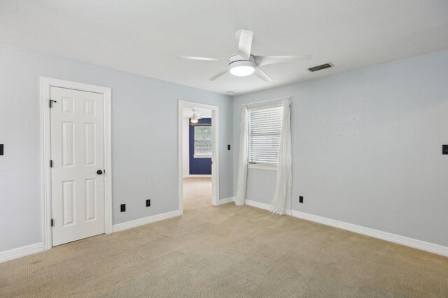 30418 La Quinta Dr, Georgetown, TX 78628 - unfurnished bedroom with light colored carpet, baseboards, and ceiling fan