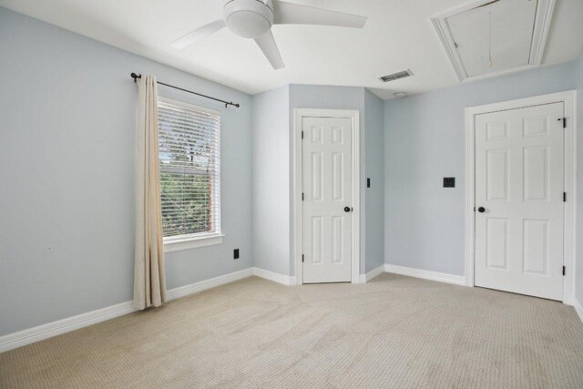 30418 La Quinta Dr, Georgetown, TX 78628 - unfurnished bedroom with attic access, light carpet, baseboards, and a ceiling fan