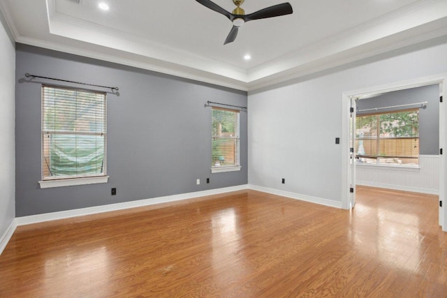 30418 La Quinta Dr, Georgetown, TX 78628 - unfurnished room with a tray ceiling, wood finished floors, ornamental molding, a ceiling fan, and healthy amount of natural light