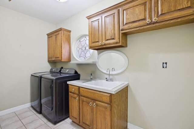 30418 La Quinta Dr, Georgetown, TX 78628 - washroom with washing machine and dryer, cabinet space, baseboards, and light tile patterned floors
