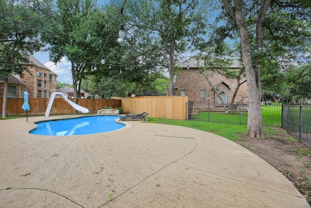30418 La Quinta Dr, Georgetown, TX 78628 - view of swimming pool featuring a water slide and a patio area