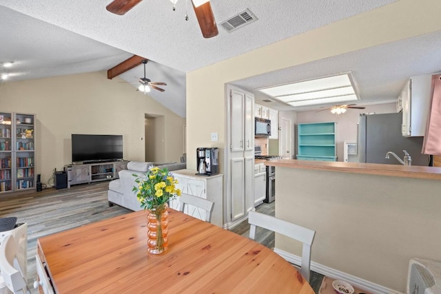 811 Timber Trl, Cedar Park, TX 78613 - dining space with a ceiling fan, wood finished floors, and a textured ceiling
