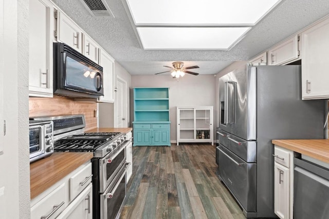 811 Timber Trl, Cedar Park, TX 78613 - kitchen featuring appliances with stainless steel finishes, butcher block counters, dark wood-style floors, white cabinetry, and a textured ceiling