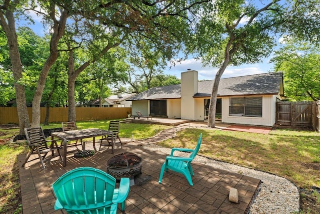 811 Timber Trl, Cedar Park, TX 78613 - back of house featuring an outdoor fire pit, a chimney, a patio, and roof with shingles