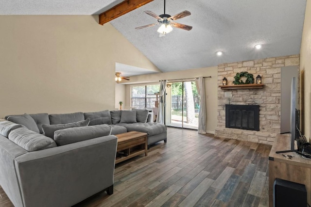 811 Timber Trl, Cedar Park, TX 78613 - living area with a ceiling fan, beamed ceiling, dark wood-style floors, a textured ceiling, and a stone fireplace