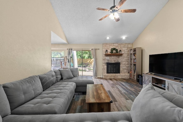 811 Timber Trl, Cedar Park, TX 78613 - living room featuring ceiling fan, a fireplace, wood finished floors, a textured ceiling, and high vaulted ceiling